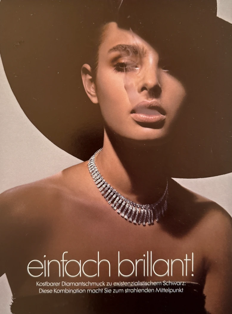 May Gil fashion - image with a large black hat and diamond necklace - editorial photo from a jewelry campaign